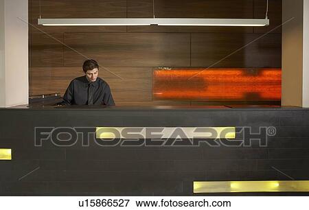 Stock Photo - Staff at reception in hotel lobby. Fotosearch