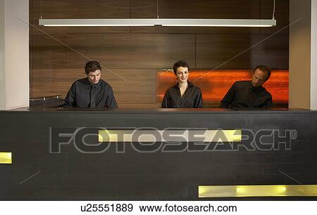 Stock Photo - Staff at reception in hotel lobby. Fotosearch