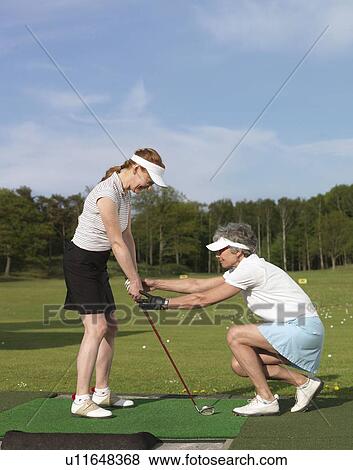 Two women at driving range View Large Photo Image Stock Photo - Two women at driving range. Fotosearch