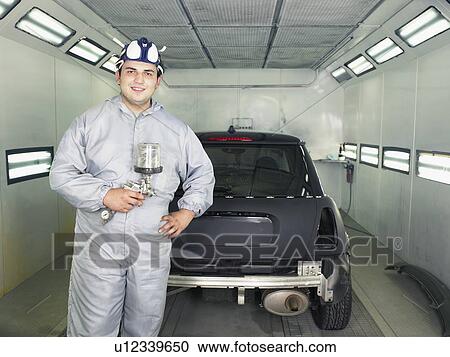 Stock Image - Worker ready to paint a car.. Fotosearch
