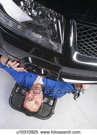 Stock Photography - Worker repairing car.. Fotosearch