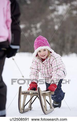 Young girl towed on sledge View Large Photo Image Stock Image - Young girl towed on sledge. Fotosearch
