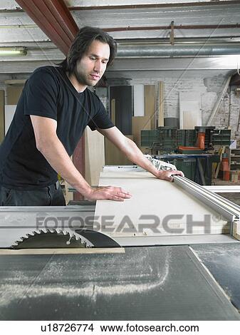 Carpenter working in his workshop. View Large Photo Image Picture - Carpenter working in his workshop.. Fotosearch