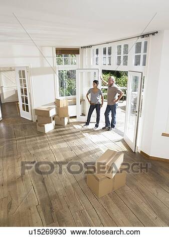 Couple moving boxes into empty house. View Large Photo Image Stock Image - Couple moving boxes into empty house.. Fotosearch