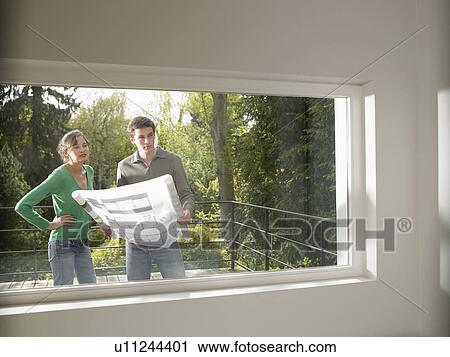 Couple with blueprint, outdoors View Large Photo Image Stock Image - Couple with blueprint, outdoors. Fotosearch