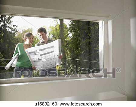 Couple with blueprint, outdoors View Large Photo Image Stock Image - Couple with blueprint, outdoors. Fotosearch