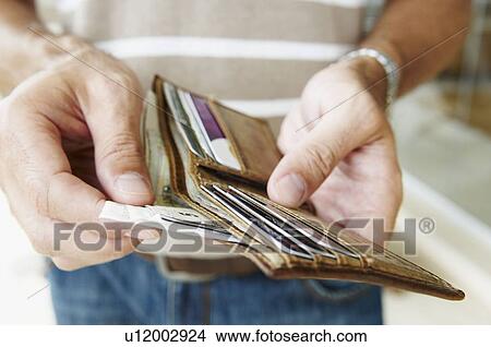 Man removes cash from wallet View Large Photo Image Picture - Man removes cash from wallet. Fotosearch
