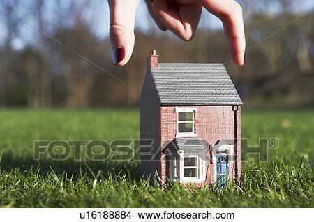 Model of house about to be picked up View Large Photo Image Picture - Model of house about to be picked up. Fotosearch