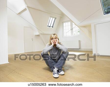 Sad-looking woman on floor in empty loft. View Large Photo Image Stock Image - Sad-looking woman on floor in empty loft.. Fotosearch