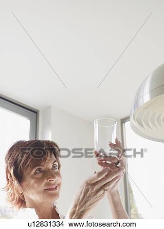 Senior woman inspecting glass View Large Photo Image Picture - Senior woman inspecting glass. Fotosearch