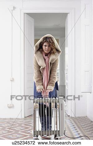 Woman huddled by radiator View Large Photo Image Stock Image - Woman huddled by radiator. Fotosearch