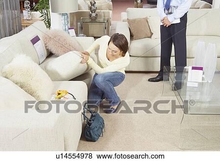 Woman looking at a sofa in a shop. View Large Photo Image Stock Photo - Woman looking at a sofa in a shop.. Fotosearch