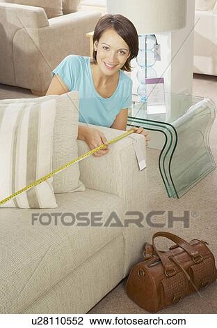 Woman measuring sofa in furniture store. View Large Photo Image Stock Image - Woman measuring sofa in furniture store.. Fotosearch