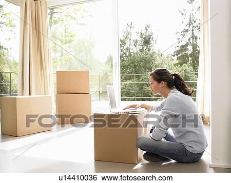 Woman on computer, moving boxes around View Large Photo Image Stock Photograph - Woman on computer, moving boxes around. Fotosearch