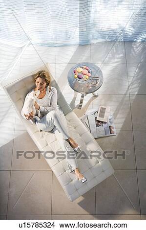 Picture - Woman Relaxing, Playing With Dog. Fotosearch