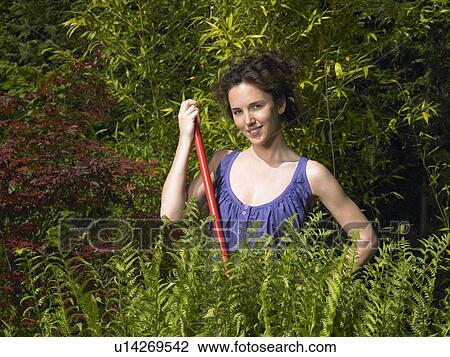 Stock Image - Woman working in the garden. Fotosearch