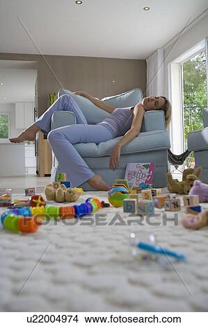 Young mother sleeping on chair View Large Photo Image Picture - Young mother sleeping on chair. Fotosearch