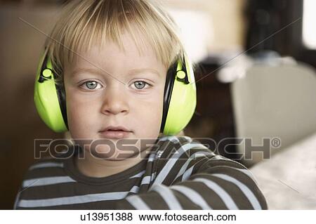 Boy wearing headphones, portrait View Large Photo Image Stock Photo - Boy wearing headphones, portrait. Fotosearch