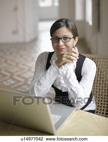 Business woman sitting with laptop View Large Photo Image Stock Image - Business woman sitting with laptop. Fotosearch