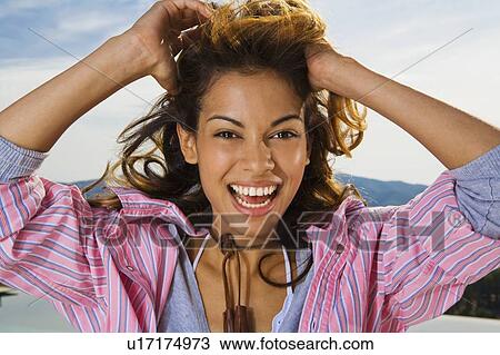 Dynamic woman smiles outside hand sin hair. View Large Photo Image Stock Image - Dynamic woman smiles outside hand sin hair.. Fotosearch
