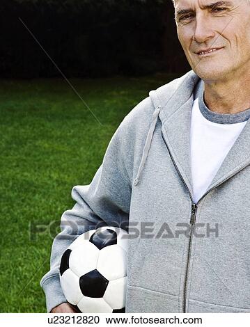 Man holding football, portrait View Large Photo Image Stock Image - Man holding football, portrait. Fotosearch