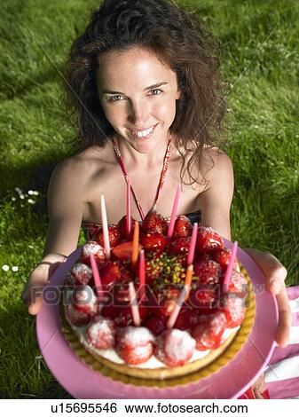 Woman holding a birthday cake, outdoors View Large Photo Image Stock Photograph - Woman holding a birthday cake, outdoors. Fotosearch