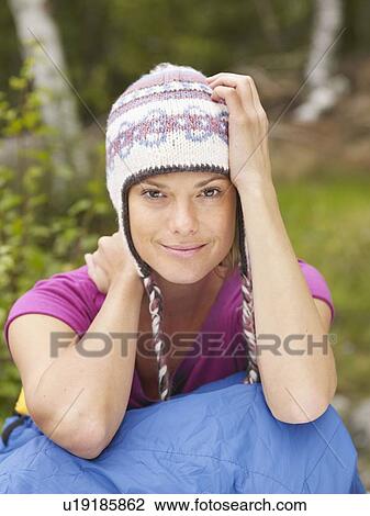 Woman sitting with a sleeping bag around waist smiling. View Large Photo Image Stock Image - Woman sitting with a sleeping bag around waist smiling.. Fotosearch