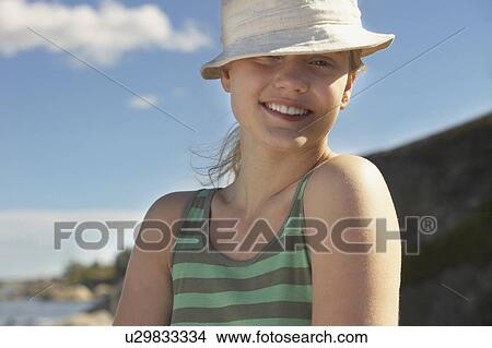 Young woman wearing sun hat. View Large Photo Image Picture - Young woman wearing sun hat.. Fotosearch