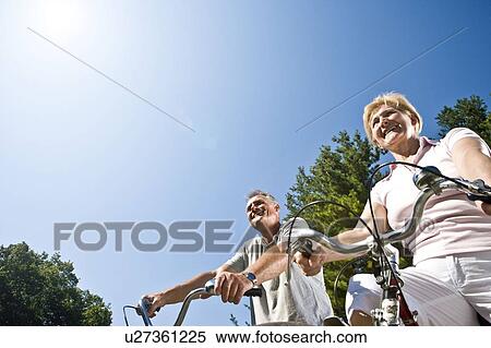 Stock Photography - Couple cycling, low view. Fotosearch