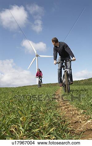Couple riding bikes View Large Photo Image Picture - Couple riding bikes. Fotosearch