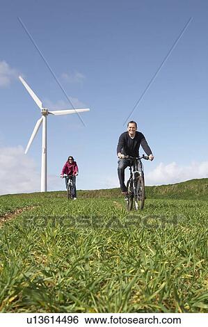 Couple riding bikes View Large Photo Image Stock Photograph - Couple riding bikes. Fotosearch