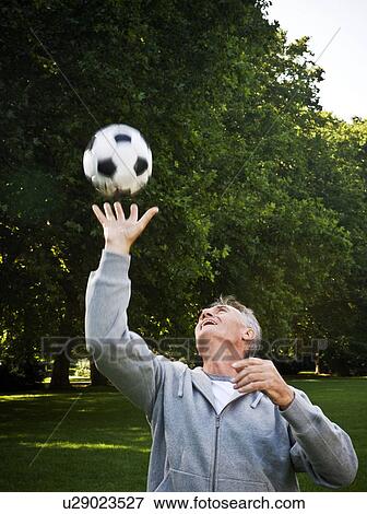 Stock Photo - Man catching ball. Fotosearch