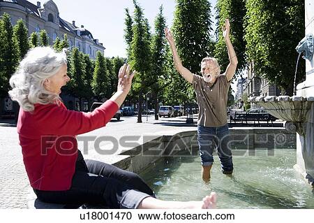 Man throwing water at woman View Large Photo Image Stock Image - Man throwing water at woman. Fotosearch