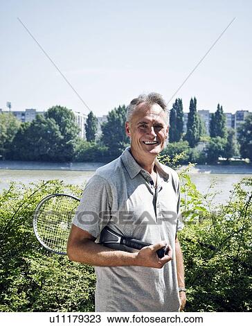 Stock Image - Man with tennis racket portrait. Fotosearch