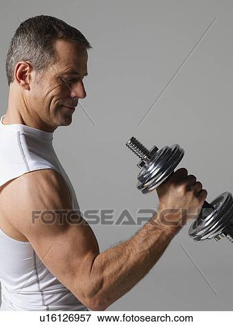 Mature man with hand weights View Large Photo Image Stock Photo - Mature man with hand weights. Fotosearch