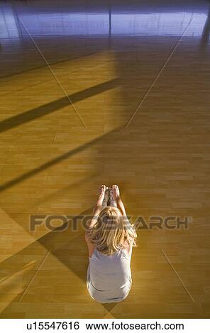 Stock Photograph - Mature woman stretching in a gym. Fotosearch