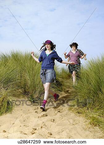 Stock Photo - Teenagers running downhill. Fotosearch