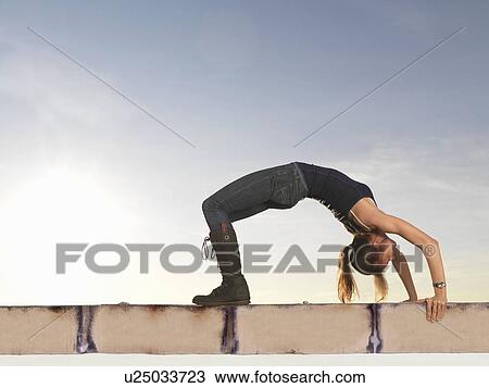 Woman bending backwards into arch View Large Photo Image Stock Image - Woman bending backwards into arch. Fotosearch