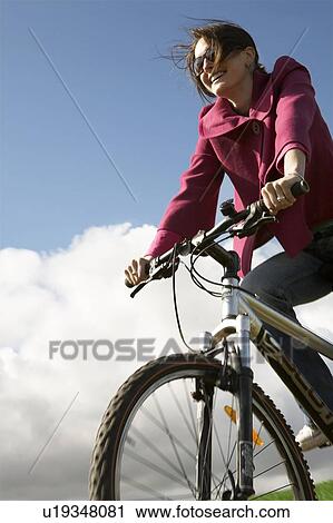 Woman riding a bike View Large Photo Image Stock Image - Woman riding a bike. Fotosearch