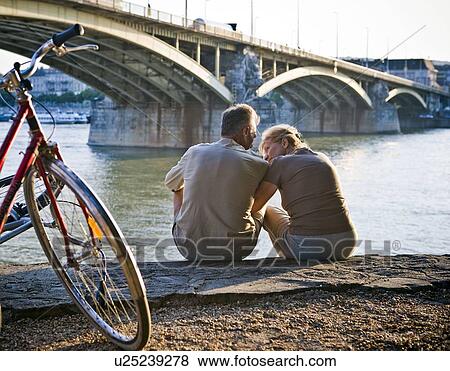 Couple by riverside View Large Photo Image Stock Photo - Couple by riverside. Fotosearch
