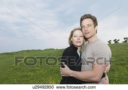 Stock Image - Couple embrace in twilight. Fotosearch