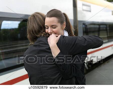 Stock Photo - Couple embracing on train station. Fotosearch