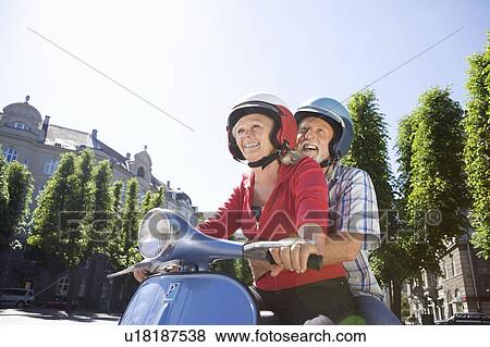 Couple on scooter View Large Photo Image Stock Photo - Couple on scooter. Fotosearch