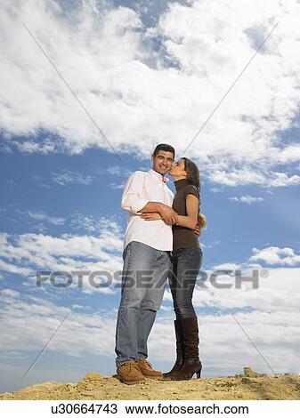 Couple posing on hill, woman kissing man's cheek, Alicante, Spain, View Large Photo Image Stock Image - Couple posing on hill, woman kissing man's cheek, Alicante, Spain,. Fotosearch