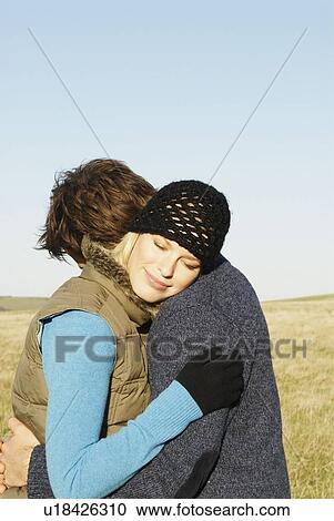 Embracing couple in countryside View Large Photo Image Stock Image - Embracing couple in countryside. Fotosearch