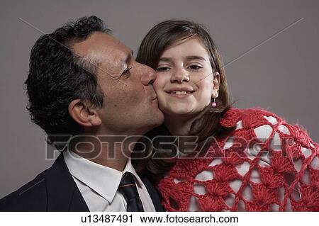 Father kissing daughter (9-11) on cheek View Large Photo Image Stock Image - Father kissing daughter (9-11) on cheek . Fotosearch