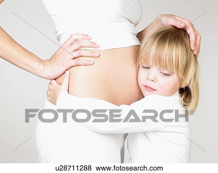 Girl holding her mother's pregnant belly View Large Photo Image Stock Photo - Girl holding her mother's pregnant belly. Fotosearch