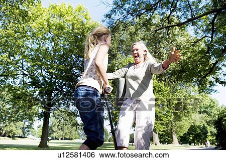 Grandmother hugging granddaughter View Large Photo Image Stock Photograph - Grandmother hugging granddaughter. Fotosearch
