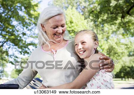 Stock Photo - Grandmother with granddaughter and bike. Fotosearch