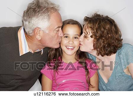 Stock Photograph - Grandpa and Mum kissing girl's cheek. Fotosearch